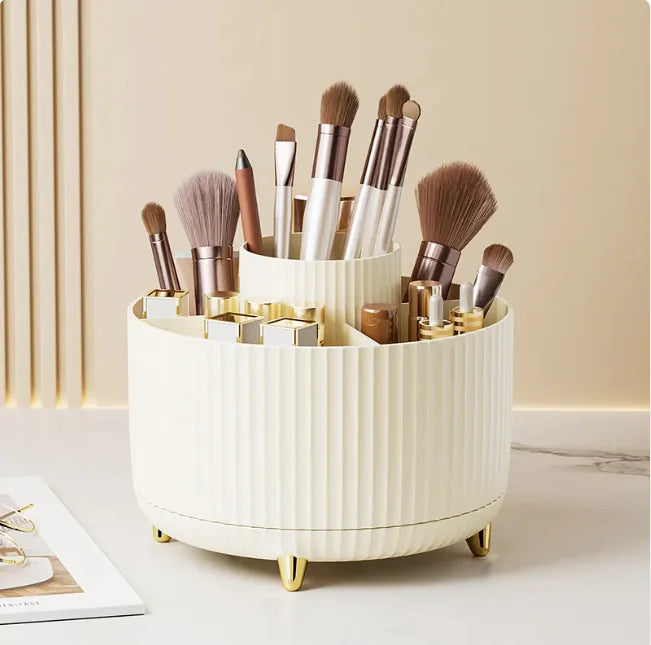 White cylindrical makeup brush holder with brushes on a light surface.