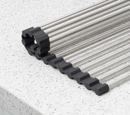 Black plastic track with metal cables on a white surface