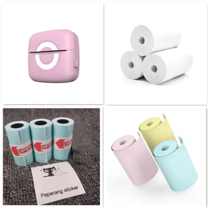 Collage of a pink device, white paper rolls, blue paper rolls with stickers, and a pink and blue roll of paper.